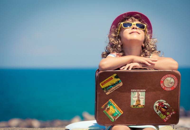 Child traveler with a suitcase on a cruise