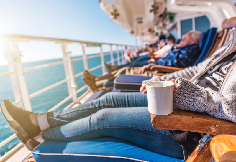 Travelers relaxing on the deck of a cruise ship