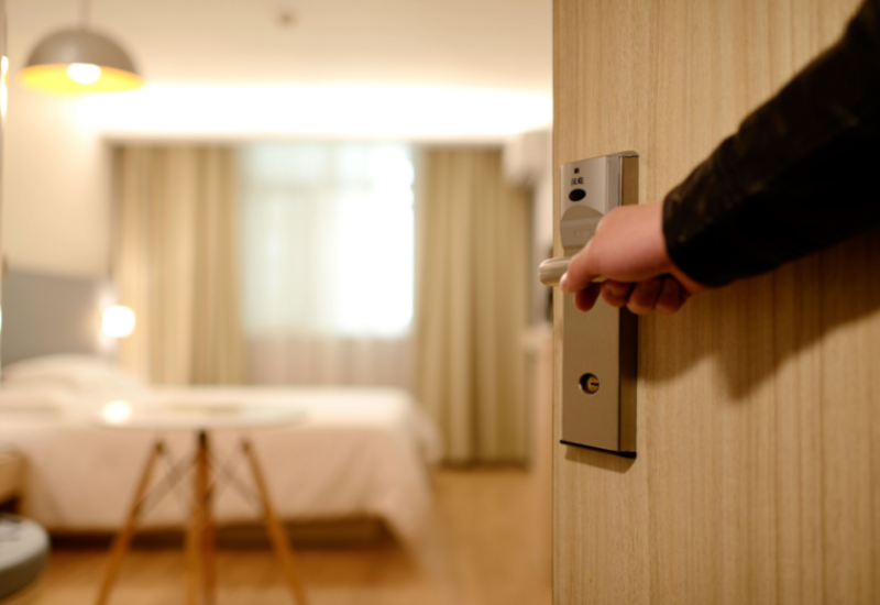 Traveler opening the door of a modern hotel room