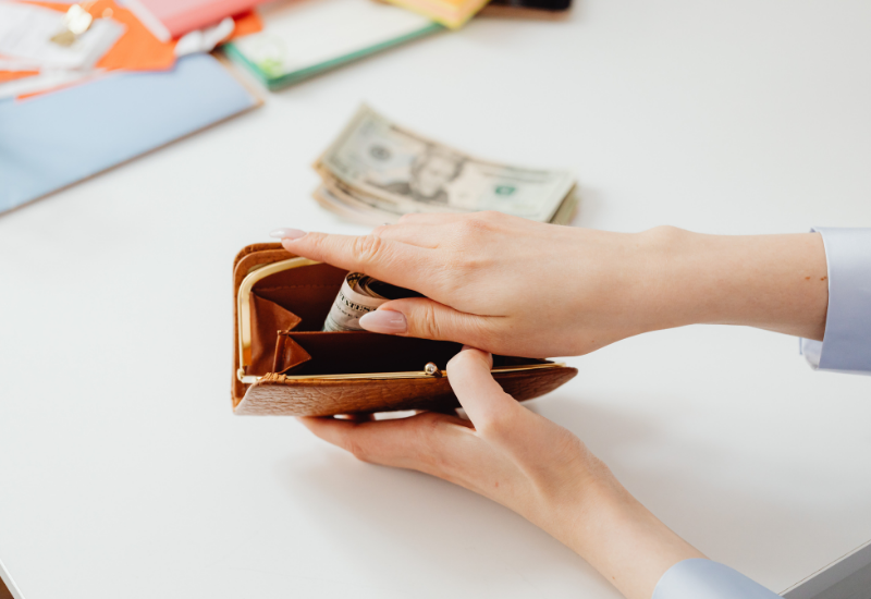 Traveler adding cash to a muggers wallet