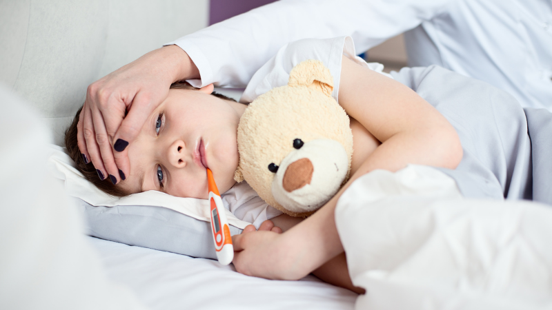 What does travel insurance cover?- Child sick in bed with thermometer