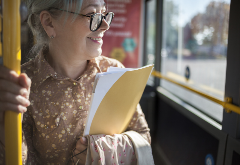 Senior-age traveler riding on a bus.